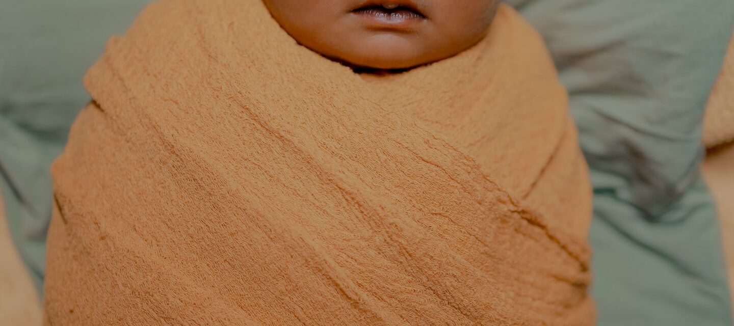 Peaceful newborn baby sleeping — infant care and fever awareness for parents