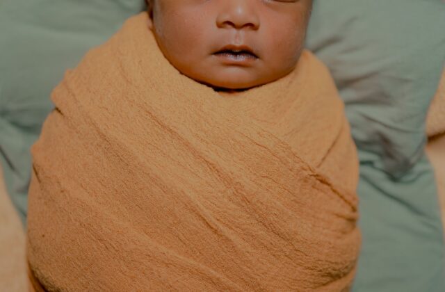Peaceful newborn baby sleeping — infant care and fever awareness for parents