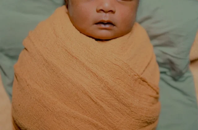 Peaceful newborn baby sleeping — infant care and fever awareness for parents