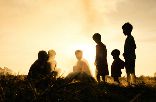 Silhouettes of children playing outdoors in the heat, representing heat stroke prevention in kids during Indian summers.