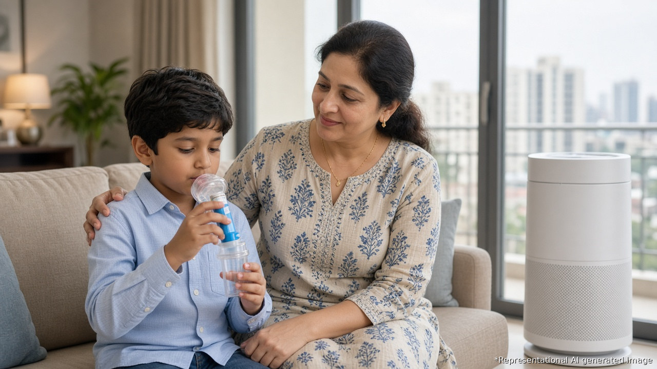 Indian mother helping her son use an asthma inhaler with a spacer at home, with an air purifier nearby during smoky Diwali-season air